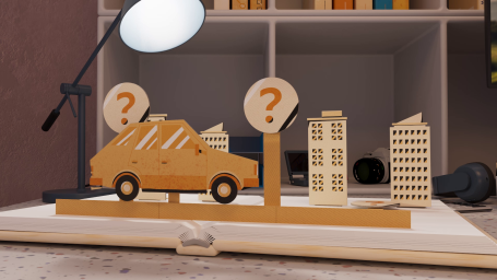 Wooden model of a car with question mark signs and miniature buildings on a desk.